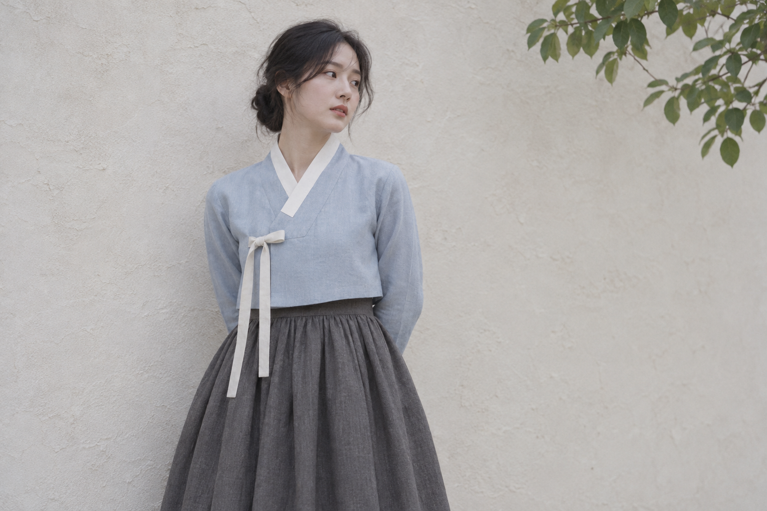Separate generated concept with a pale blue jacket and gray skirt beside a plain wall